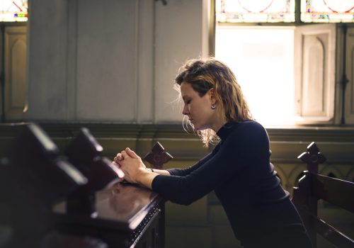 Woman praying in the church